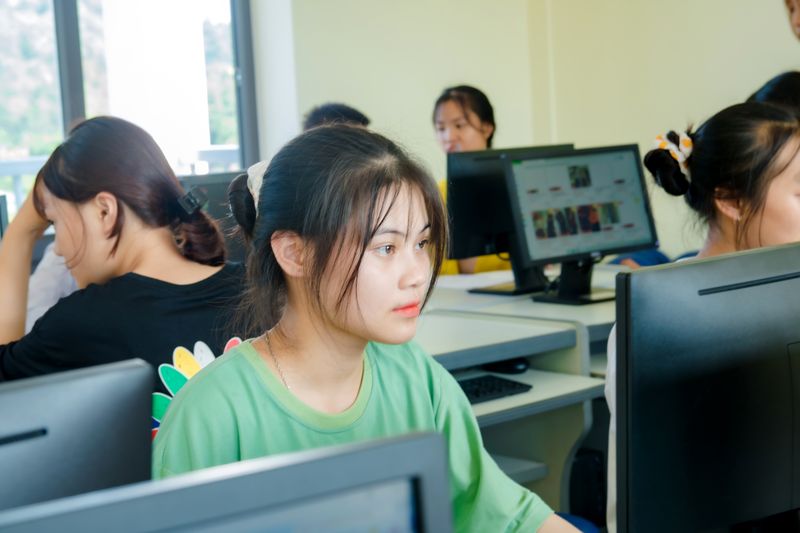 Student focused on a computer screen in a school computer lab