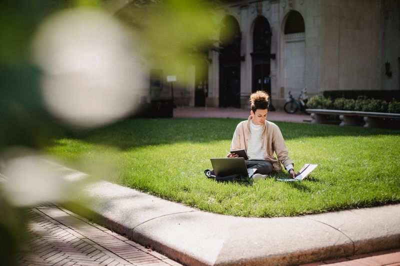 Student studying on the campus of a Public Ivy or Little Ivy school