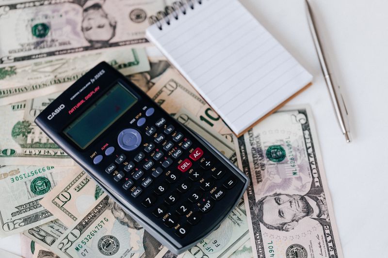 Calculator and cash representing Brown pre-college program tuition costs