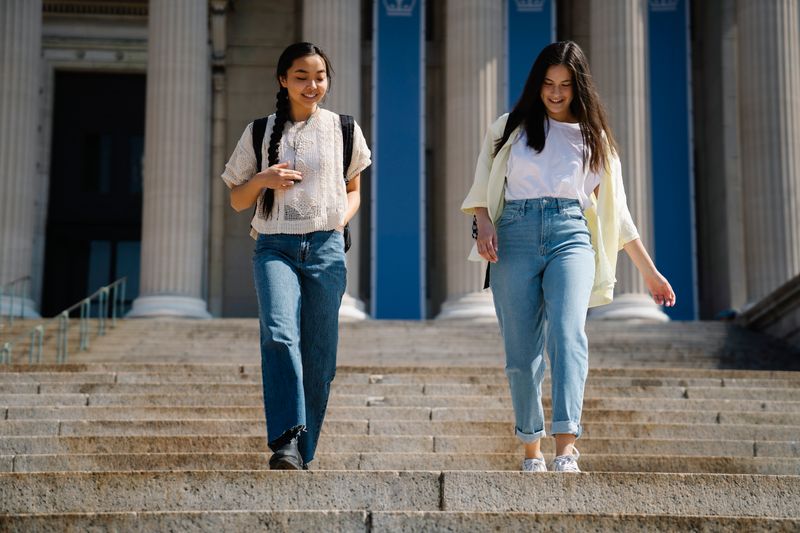 Students walking together on a college campus during a pre-college summer program