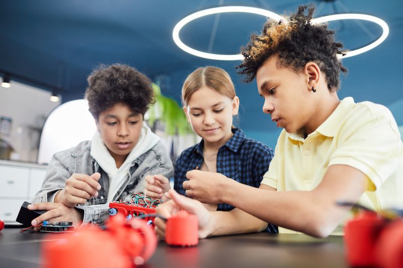 Students building a robotics circuit project for a science fair