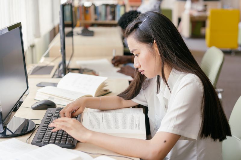 Focused student writing a cold email that gets a response