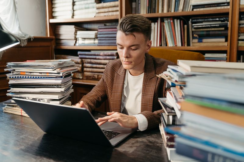 Student researching founders and authors before using cold email templates to reach out