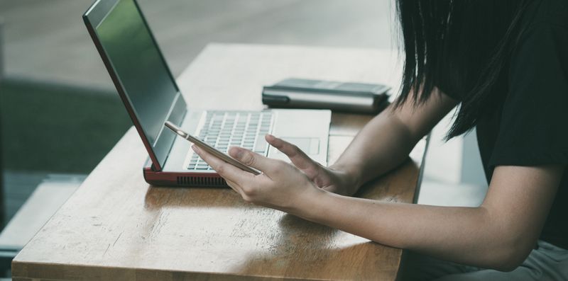 Student checking for a response after using cold email templates for founders and authors