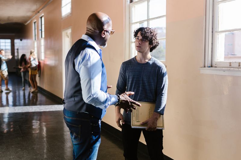 Student discussing a fee waiver form with a school counselor