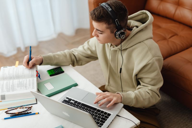 Student working on a laptop to submit a college application before recommendations arrive