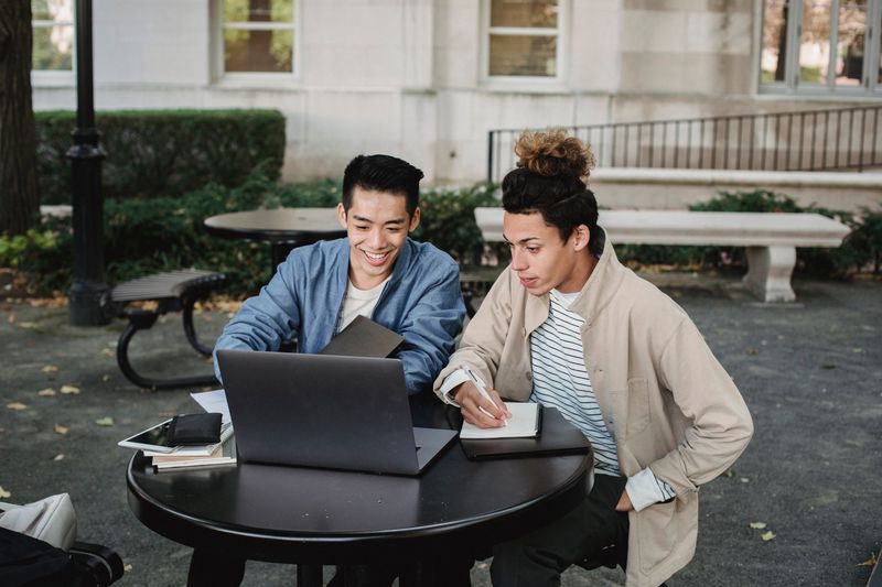 Students working together on a research project, distinct from college counselor application advising