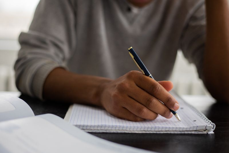 Student writing notes while deciding what not to include in the additional information section
