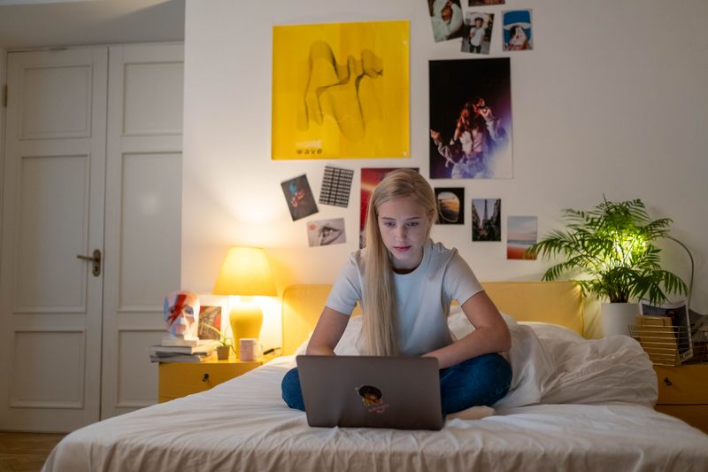 Teen student on a laptop deciding what to write in the common app additional info section