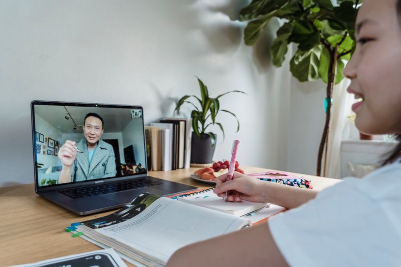 Student on a video call with an instructor for an online precollege course