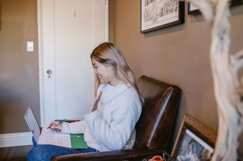 Student on a laptop in a cozy home setting checking pre-college program eligibility