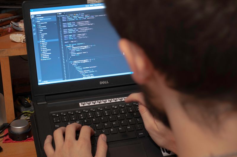 Close-up of hands typing code on a laptop for a computer vision project