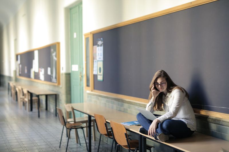 High school student sitting alone thinking about whether they need a college counselor