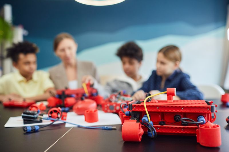 Students building a robotics project in an engineering summer program
