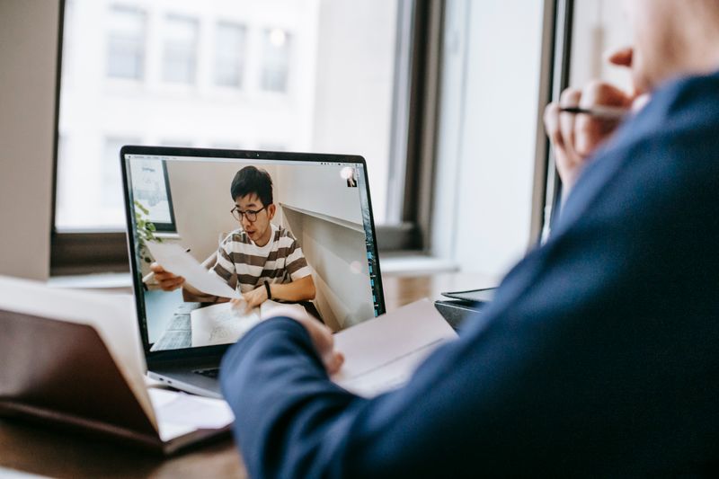 Student in a mentor session weighing free research opportunities against paid programs