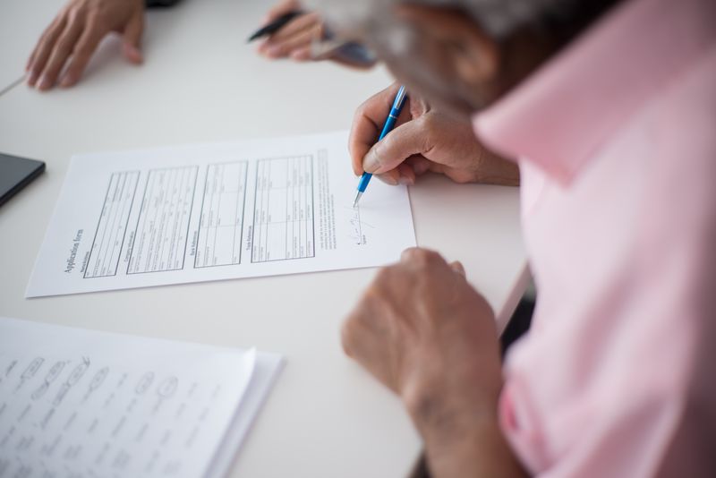 Student signing a Georgetown pre-college program application form
