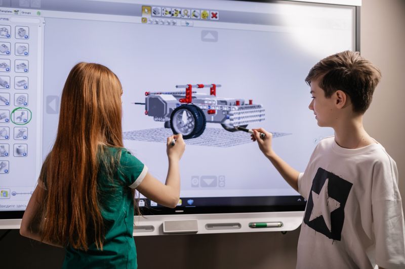Two students collaborating on a coding and design project for Google Code Next