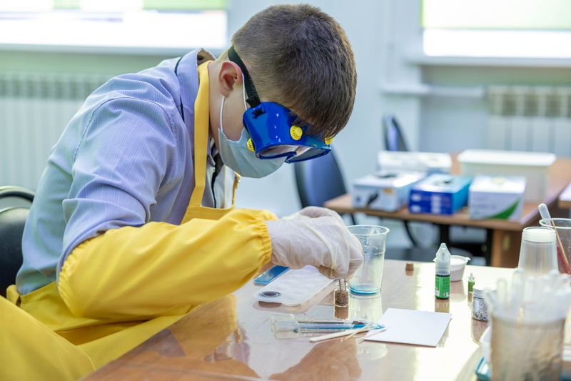 High school student preparing a research competition project in a laboratory