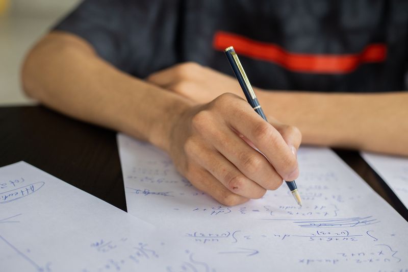 Student calculating how much high school interns get paid