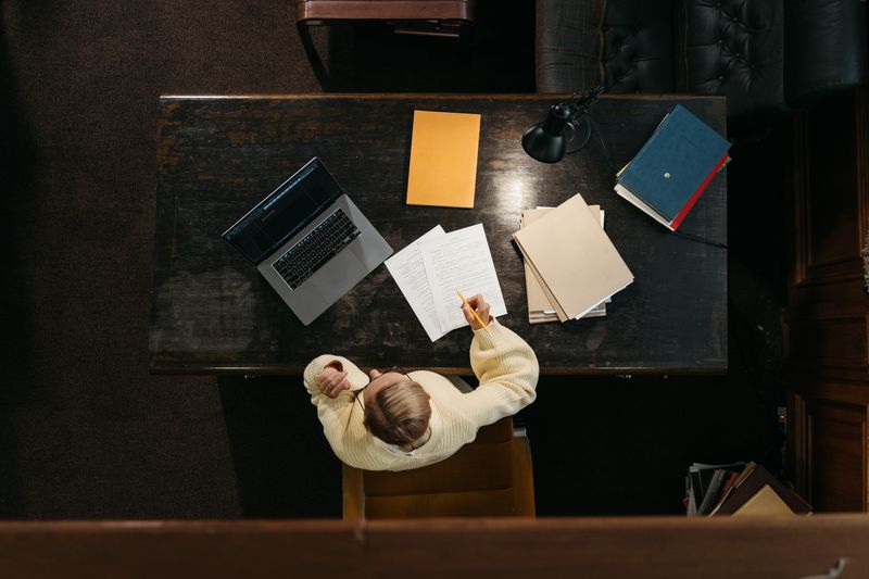 Overhead view of a student preparing application materials for the cosmos summer program