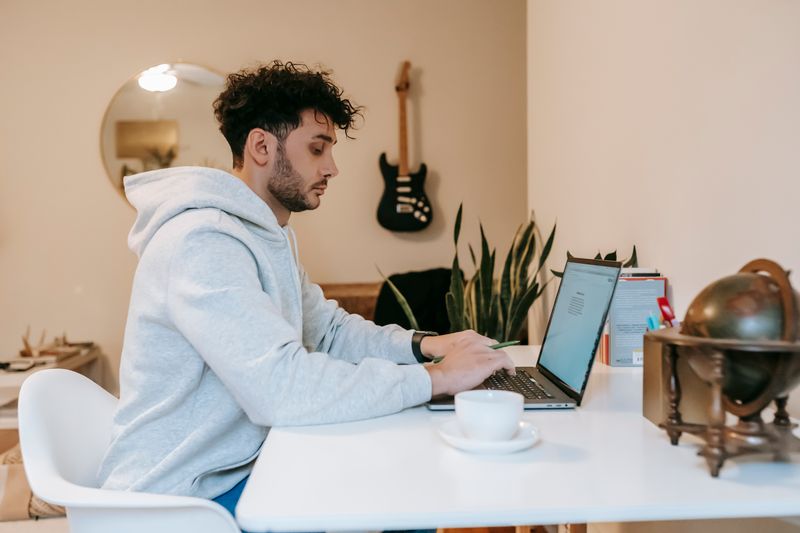 Student working at a laptop to build a standout college application
