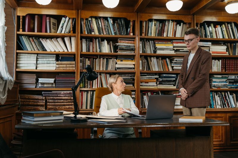 Professor working at a desk reviewing research in a university office