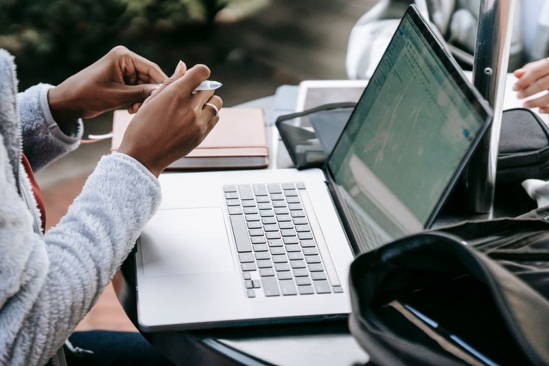 Student typing on a laptop writing an additional information section entry