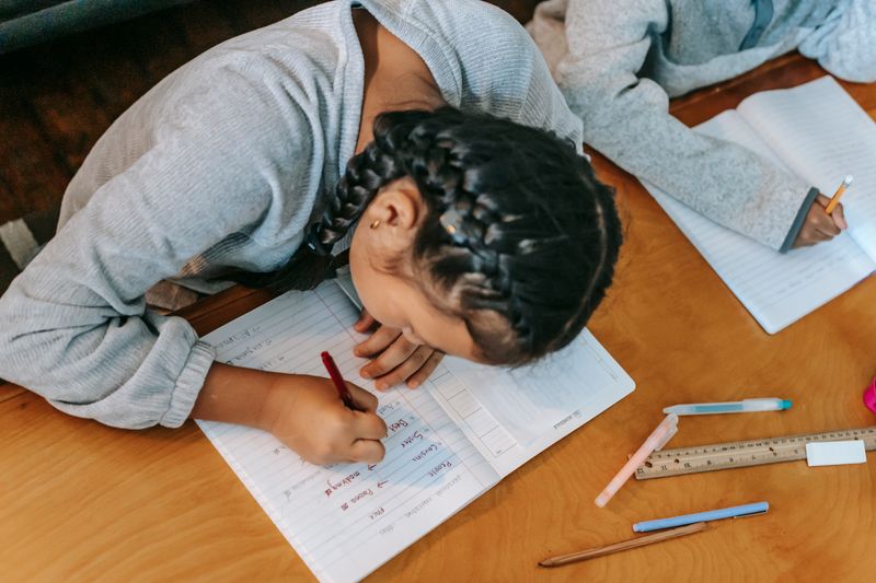 Student writing an ISEF abstract step by step in a notebook