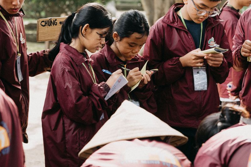 Group of students taking notes outdoors during a field investigation like the IESO team activity