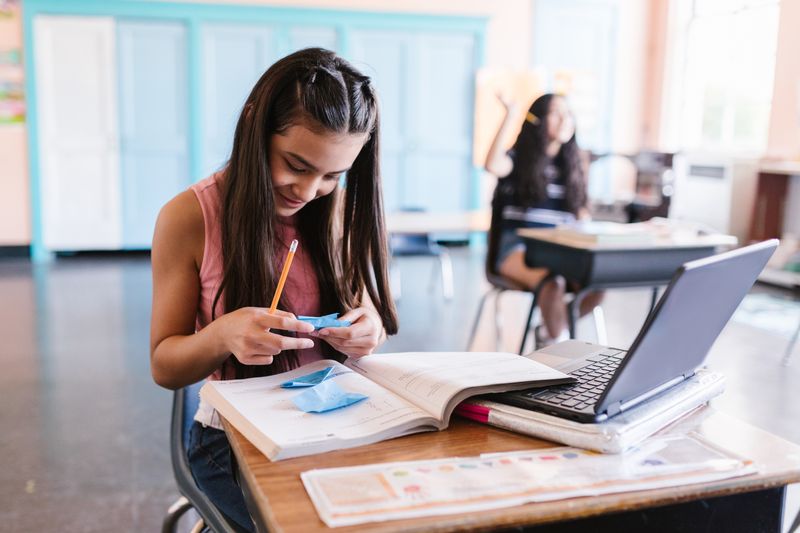 Student reviewing ISEF research plan format requirements at a desk