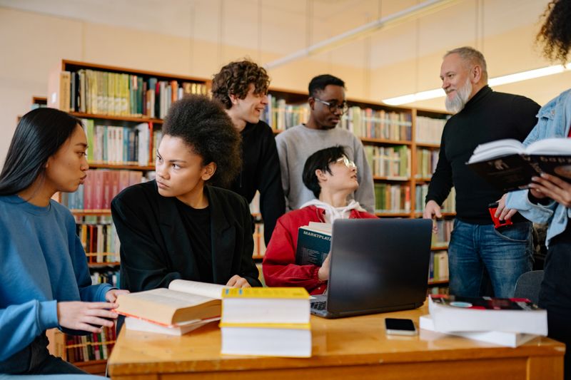 High school students collaborating on a project in a library setting