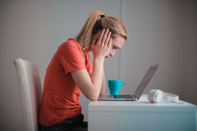 Student looking worried at a laptop about a late recommendation letter