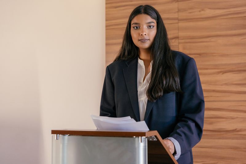 Student presenting at a podium related to paid law internship opportunities