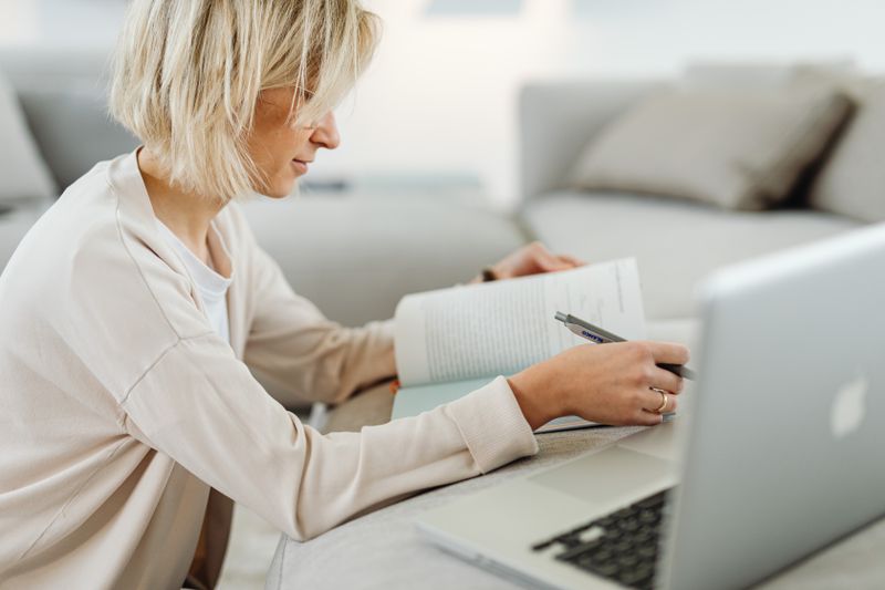 High school student doing online research from home on a desktop computer