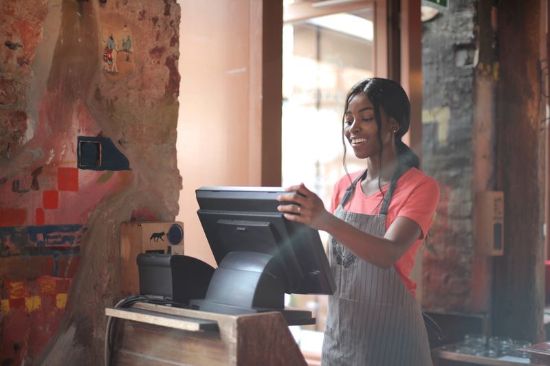 Student working a paid internship position at a retail counter