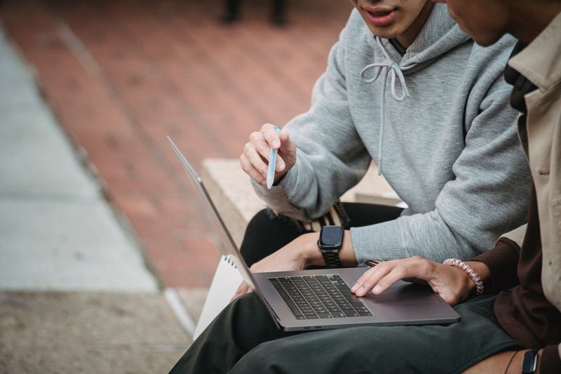 Student comparing the cost of a polygence research program on a laptop