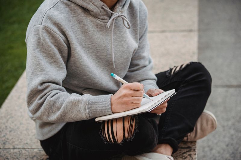 Student crossing out a weak research paper hook while revising