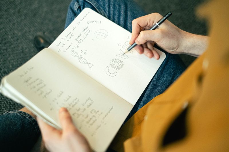 Student brainstorming research paper introduction ideas in a notebook