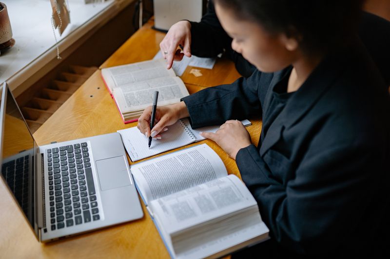 Student reviewing and organizing research notes to avoid outline mistakes