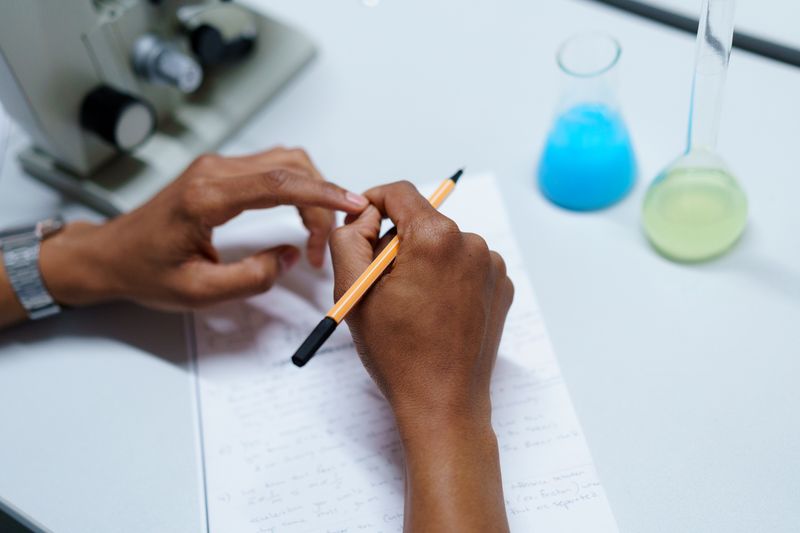 Student writing detailed lab notebook steps for a research paper