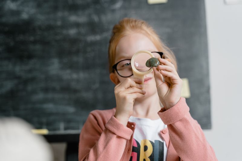 Student using a magnifying glass for rock and mineral identification practice