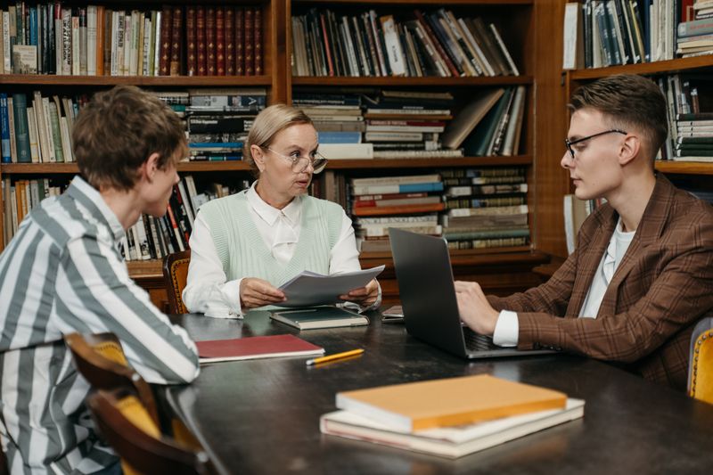 High school student meeting with a professor to discuss a research collaboration