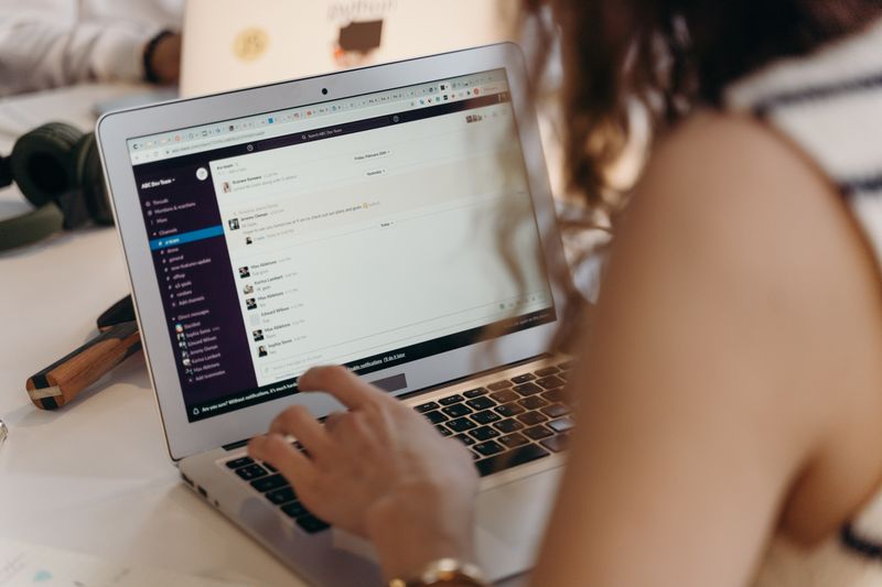 Hands typing a cold email on a laptop to apply for a summer internship