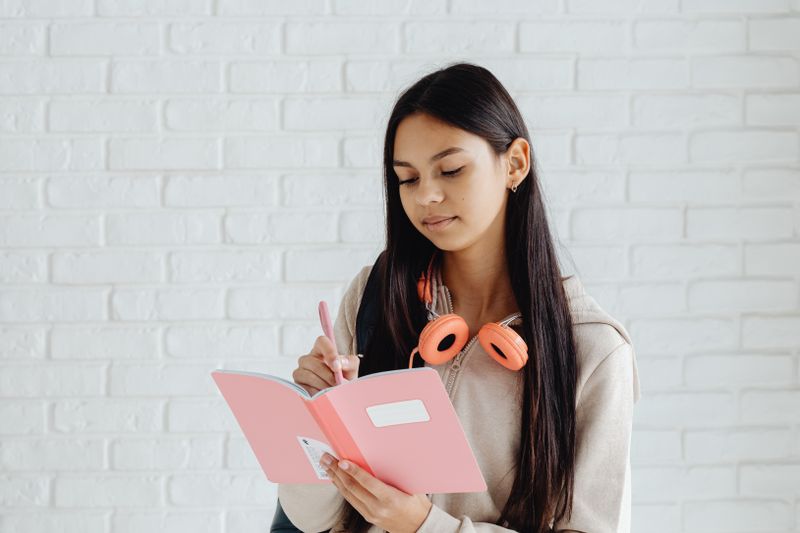 Teenager writing internship application deadlines in a planner