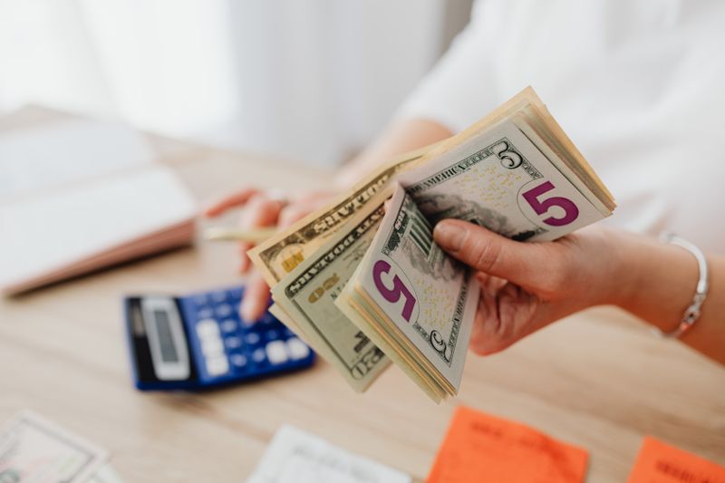 Counting money and using a calculator to budget for UCSB RMP program costs