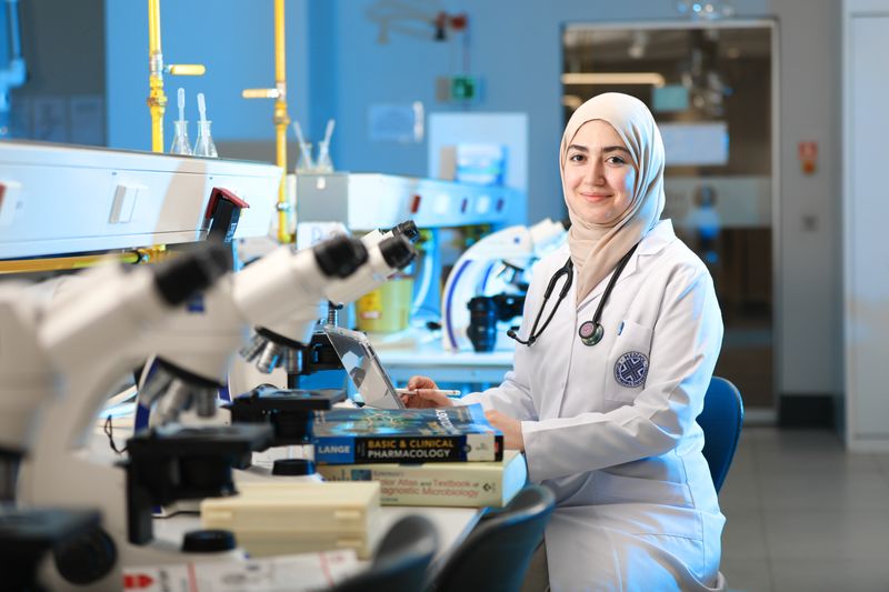 Student working with lab equipment during a research mentorship program