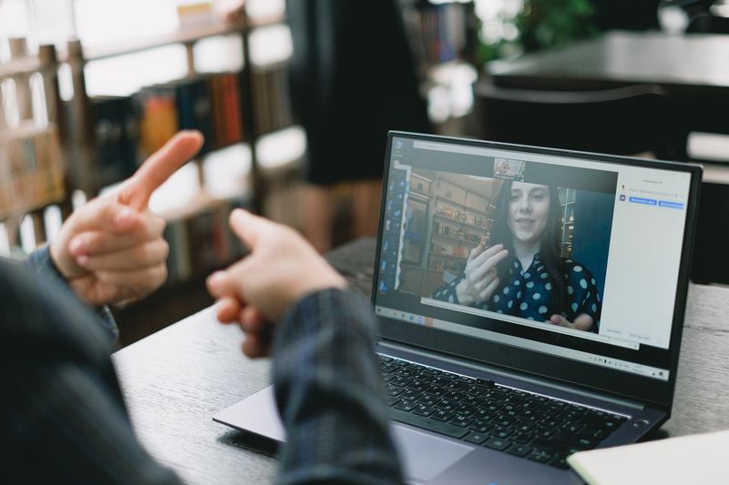 High school student on a virtual video call with a research mentor online