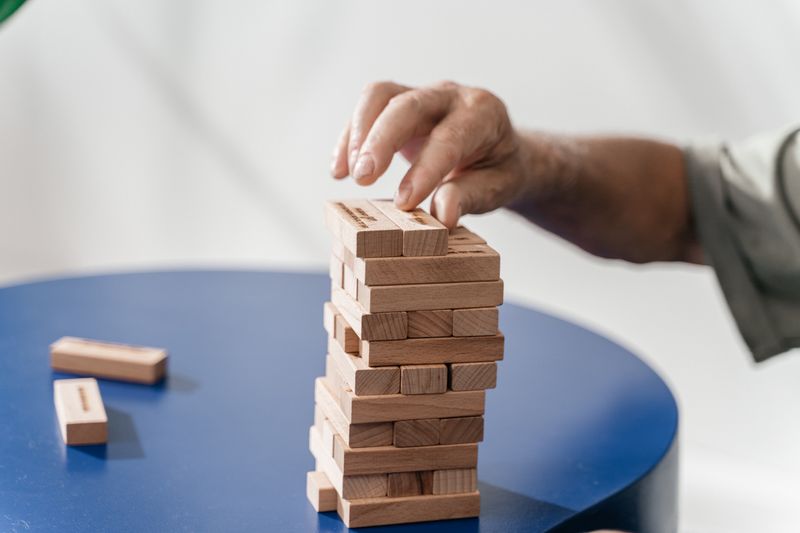 Hand carefully placing a piece, showing the precision a Write It Do It builder needs