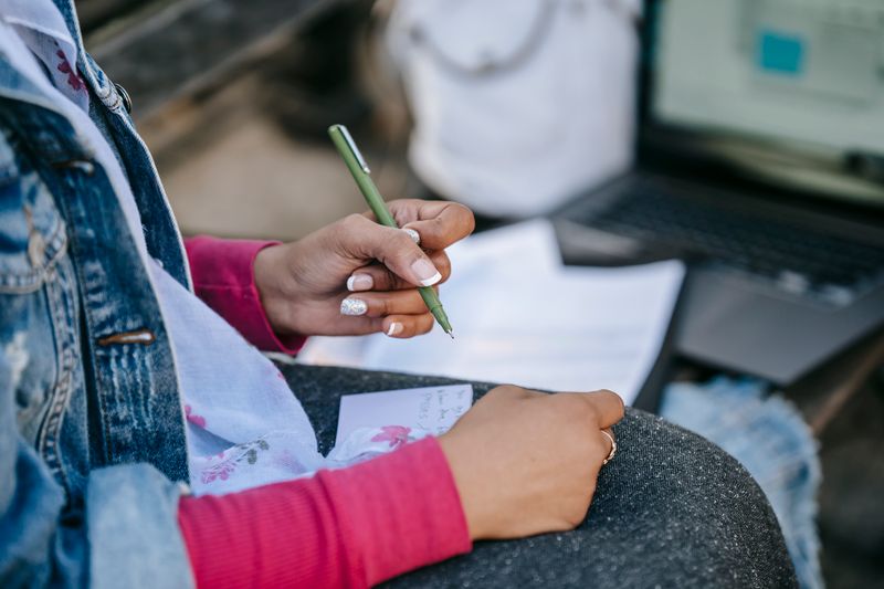 Student typing a discussion section on a laptop
